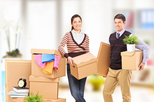 Professional movers loading a van for a Charlton relocation