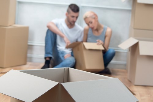 Local movers organizing fragile items for transport